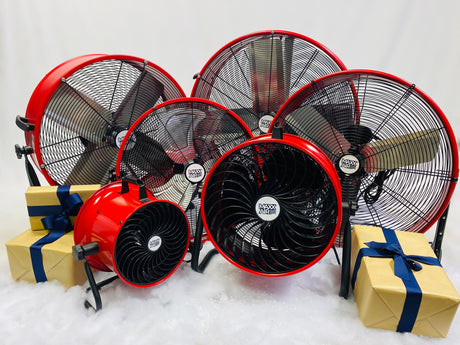 Our red Maxx Air series of drum and floor fans sit next to presents and snow for the holiday season.