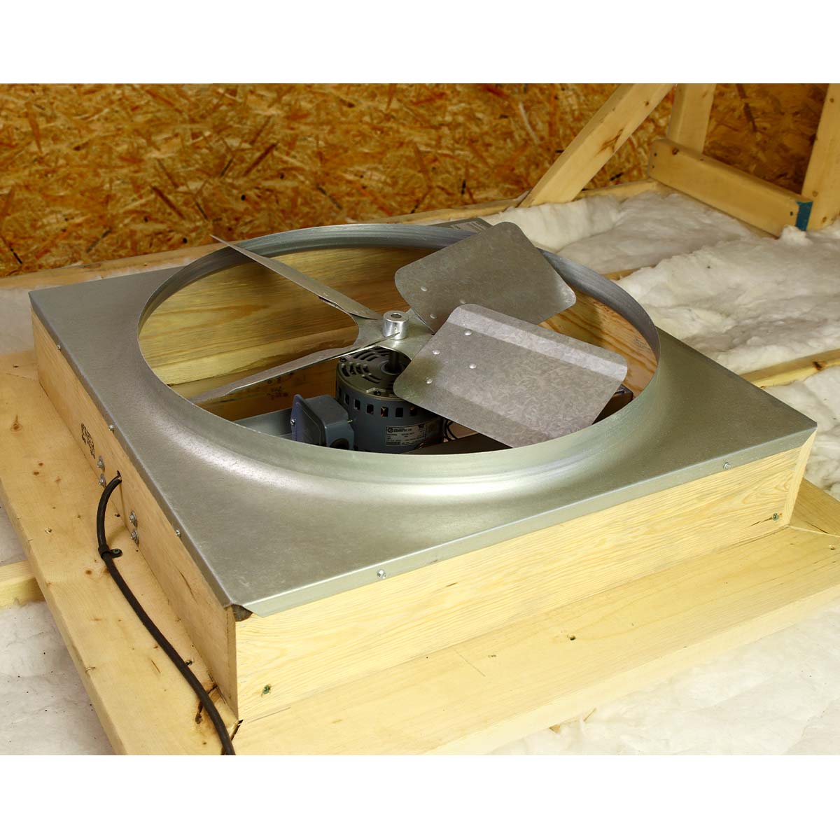 Direct drive whole house fan installed in attic of home to create a cooling effect throughout the whole house when in use.