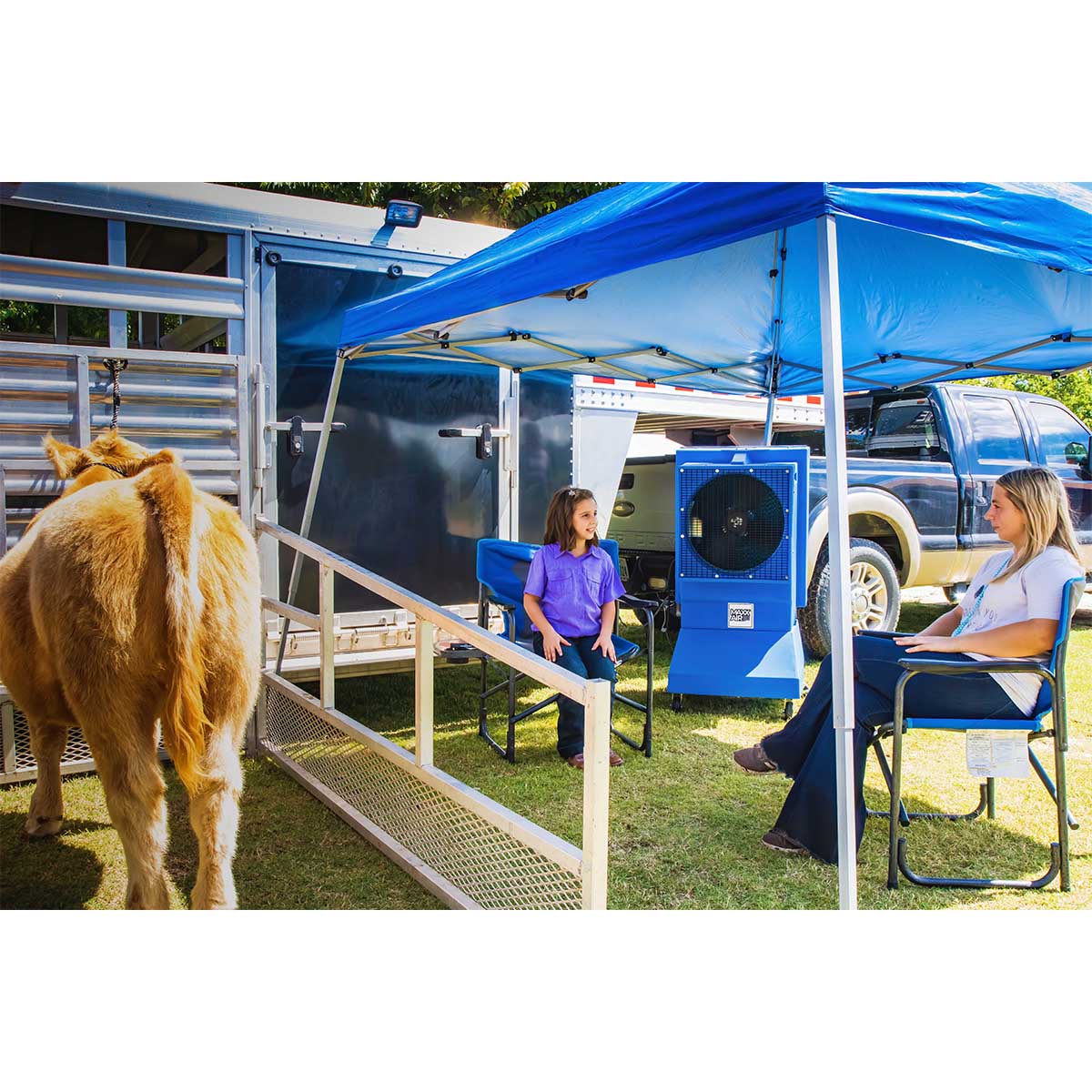The 18 in. air cooler creates comfort outdoors under a tent as young competitors wait for the start of a stock show.