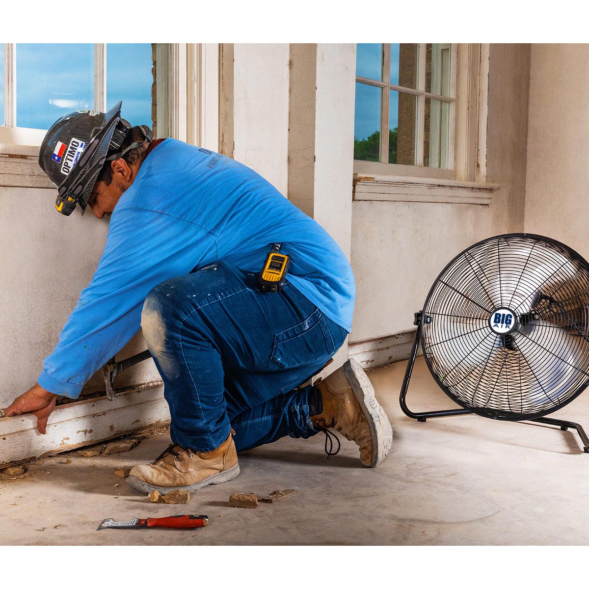The heavy duty 20 in. floor fan cools a construction worker on the job.