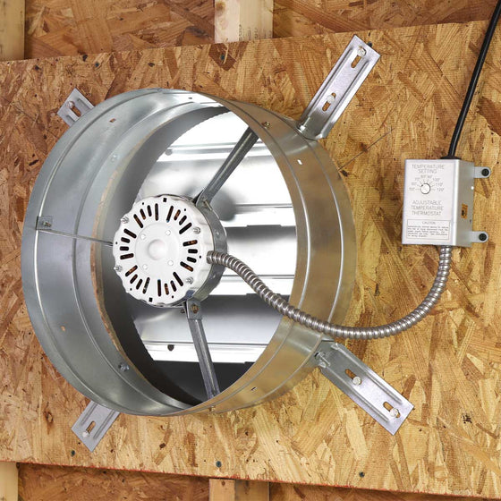 A gable fan installed in an attic space exhausts hot air out of the attic, providing ventilation and protecting roofing components from heat damage.  