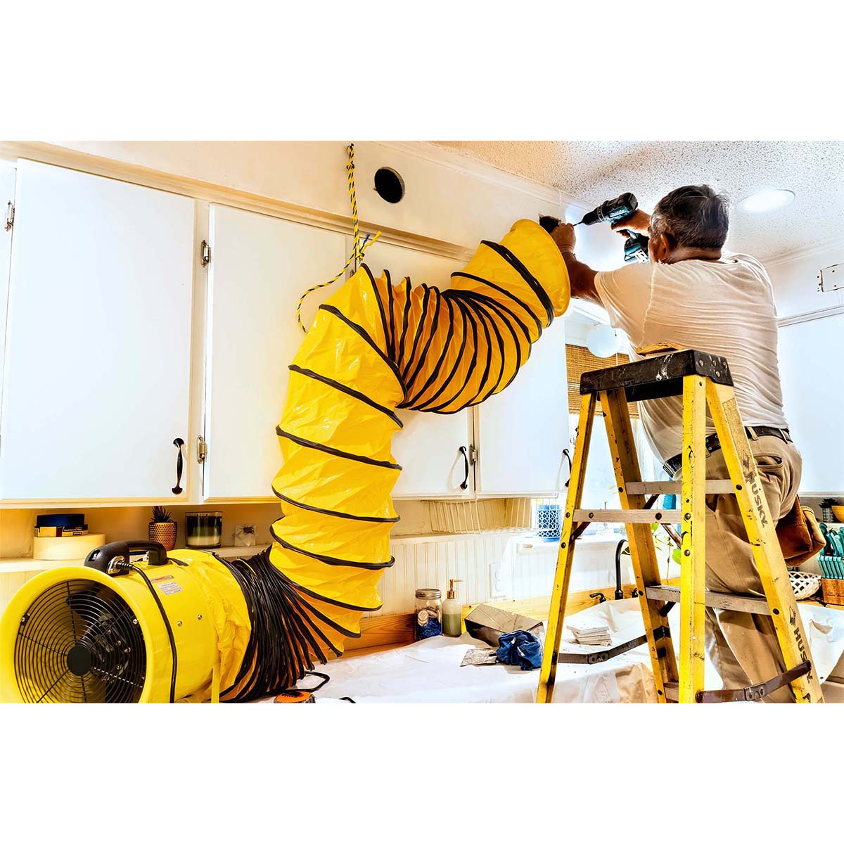 The hanger rings on the HVHF hose allow this professional contractor to effectively pull dust away from his work area in a home.